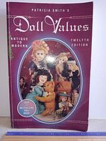 Front cover of the 1996 Patricia Smith's Doll Values book showing multiple antique and vintage dolls and a burgundy background.