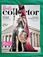Front cover of Spring 2010 Barbie Collector magazine showing Barbie dressed in warrior costume with shield and helmet standing in front of classical architecture.