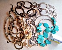 Photo showing all five necklaces together including metal chain links, beaded and stone elements in gold, silver, bronze and turquoise tones.