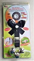 Front view of the potty training door bell chime in original packaging featuring two silver bells on black plastic base and sealed DVD case.