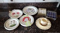 Portmeirion Botanic Garden plates including floral pattern plates and Bunnykins cup with saucer and small plates on countertop