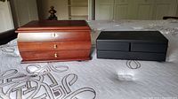 Image showing both jewelry boxes side by side on a bed.