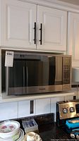 Full view of stainless steel Panasonic microwave on countertop