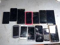 Photo showing 13 untested mobile phones including multiple smartphones with various screen conditions and a BlackBerry device with physical keyboard.
