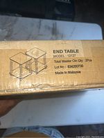 Photo showing box label with model number '12127' and the quantity '2 pcs', end table illustration, made in Malaysia