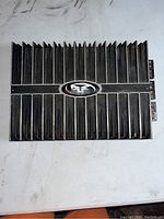 Top view of black car audio amplifier with vertical heat sink fins and Rockford Fosgate emblem center top.