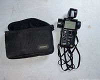 Light meter and its carrying case laid on white surface