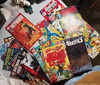 Top view of 16 comics spread showing cover art from The Punisher, The Terrifics, E-Force, Skyward, Batman, Predator and others.
