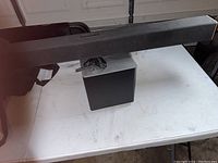 Black Vizio soundbar and wireless subwoofer displayed on a white table, showing overall appearance.