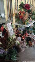 Overview of fall-themed decorations including a terra cotta turkey, autumnal floral arrangements, scarecrow figures, and craft table in unfinished basement.