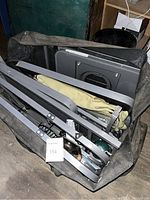 Unassembled metal frame, foldable tables, fabric bag seen from above