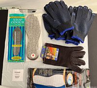 Lot of gloves and foot inserts including two sets of insoles and blue grip and brown insulated gloves.