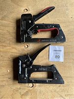 Top view photo showing two heavy duty staplers, one branded ProSniper All in 1 and the other labeled Notaker Action with red and black handle grips.