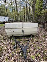 Front view of the pop up camper with closed canvas and trailer hitch.