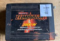 Front top view of the MotoMaster Eliminator 2000W power inverter showing branding and surface wear.