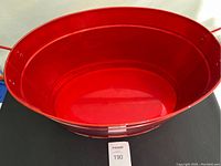 Top and interior view of the bright red metal tub showing its oval shape, glossy finish, and clean interior.