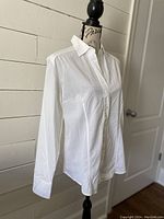 Side angled view of white Van Laack blouse on mannequin showing front button closure and long sleeves.