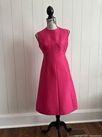 Front view of dress on mannequin showing color, neckline and skirt silhouette