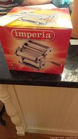 Photo showing Imperia pasta maker box with brand name and image of pasta maker on front.
