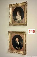Both oval portraits hung on wall with lot number sticker visible