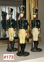 Three hand-painted soldier figurines displayed in front of mirror