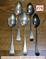 Five spoons laid flat showing bowls and handles