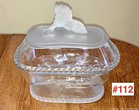 Clear EAPG comport with frosted lion figure lid resting on top and clear body with applied twisted rope rim detail.