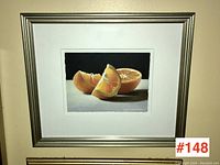 Front view of framed artwork showing orange still life