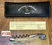 Folded corkscrew with ivory tone handle and accompanying black leather case stamped Chateau Laguiole Vialis.