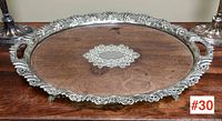 Full top view of a late Victorian / Art Nouveau serving tray with an ornate silver-plated rim, detailed handles, and dark wooden surface with central silver cartouche.