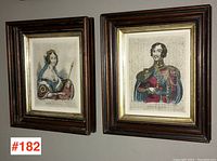 Pair of framed coloured prints of Queen Victoria and Prince Albert hanging on wall.