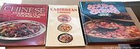 Three cookbooks side by side: Chinese Cooking Class Cookbook, Caribbean Cooking, Soul Food Stew Cookbook.