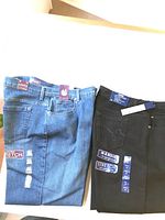 Two folded pairs of ladies jeans, one black Bandolino Amanda, one denim Gloria Vanderbilt, both size 16 average with stretch fabric tags.