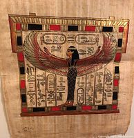 Clear focused image of papyrus art showing winged Egyptian Goddess Isis with hieroglyphs and bordered geometric design