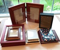 Photo showing all frames and albums laid out on a table with outdoor background