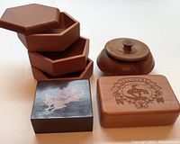 Five wooden boxes arranged close together showing detail and finish