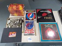 Overview photo showing Aerosmith Box of Fire 12 CD box set, Steven Tyler Out on a Limb book, Shutterfly photo book, Grateful Dead magazine, Phil Lesh book, 12x12 album frame, 12x12 ACE picture, and Vic Firth drumstick