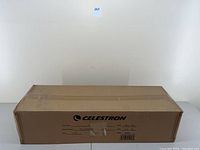 Sealed cardboard box labeled Celestron PowerSeeker 80EQ telescope front view.