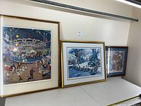 Three framed prints shown side by side: Carousel, Ducklings in Boston Public Garden, floral still life.