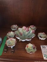 Photo showing the entire set including one large serving bowl and five small bowls arranged on a wooden surface.