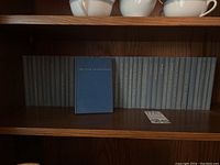 Front view of the 40 volume Yale Shakespeare book set in blue cloth covers with gold lettering on the spines.