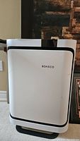 Front view of Boneco P500 air purifier showing white body with black trim and brand logo.