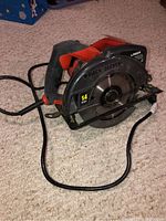 Front angled view of Black & Decker circular saw showing blade guard, handle and cord