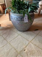Front view of the large ceramic pot showing its round shape, wide rim, and floral painted design.