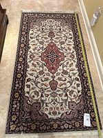 Full view of rug showing overall pattern, color, and tassel fringe