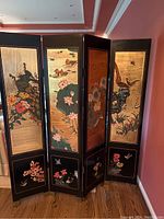 Full view of front side showing four connected panels with gold-tone backgrounds and bird and floral motifs