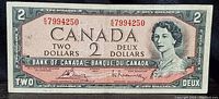 Front side of 1954 Canadian $2 banknote showing Queen Elizabeth II portrait, serial number K/2 7994250, bilingual denomination text and signatures.