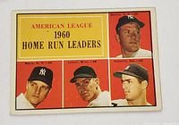 Front view of 1961 Topps #44 card showing American League 1960 Home Run Leaders with player portraits of Mantle, Maris, Lemon, and Colavito on red and yellow background.