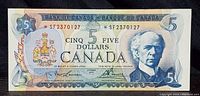 Front of the 1972 Canadian $5 note showing serial numbers with asterisks and portrait.