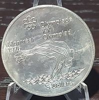 Front side of the coin showing the diver design, Montreal 1976 Olympic references, and 5 Dollar denomination.